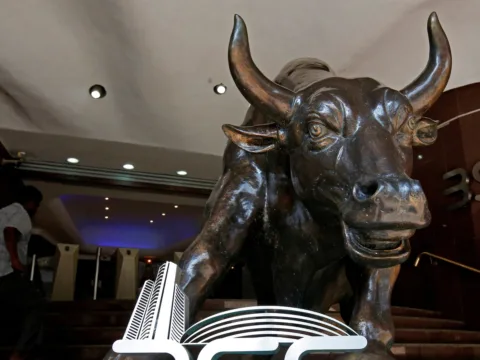 File photo: The Bombay Stock Exchange logo is seen under a bull statue at the entrance of their building in Mumbai (REUTERS)