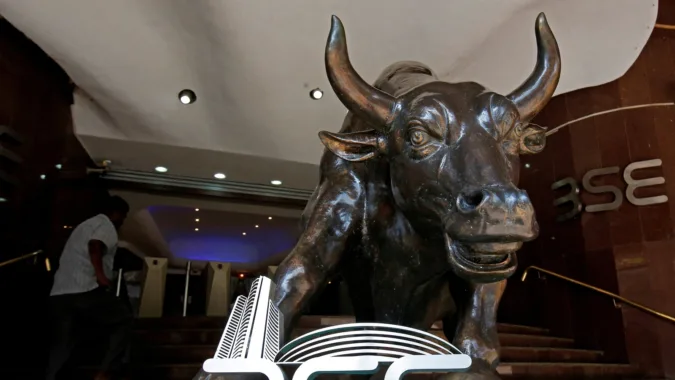 File photo: The Bombay Stock Exchange logo is seen under a bull statue at the entrance of their building in Mumbai (REUTERS)