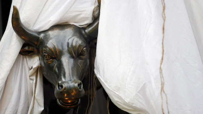 Sensex, Nifty open positive amid Middle East concerns, fund outflows File photo: A bronze replica of a bull is seen at the gates of the Bombay Stock Exchange (BSE) building in Mumbai (REUTERS)