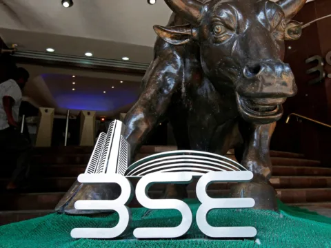 File Photo: The Bombay Stock Exchange logo is seen under a bull statue at the entrance of their building in Mumbai (REUTERS)