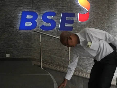 A man touches the stairs as he arrives at the Bombay Stock Exchange (BSE) building in Mumbai (REUTERS/File)