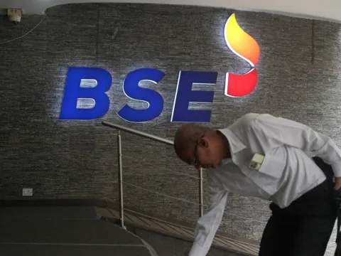 A man touches the stairs as he arrives at the Bombay Stock Exchange (BSE) building in Mumbai (REUTERS/File)
