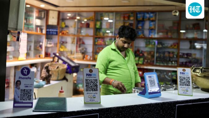 QR codes of digital payment firms PhonePe and Paytm are seen on the counter of a grocery store in Ahmedabad (REUTERS/File)