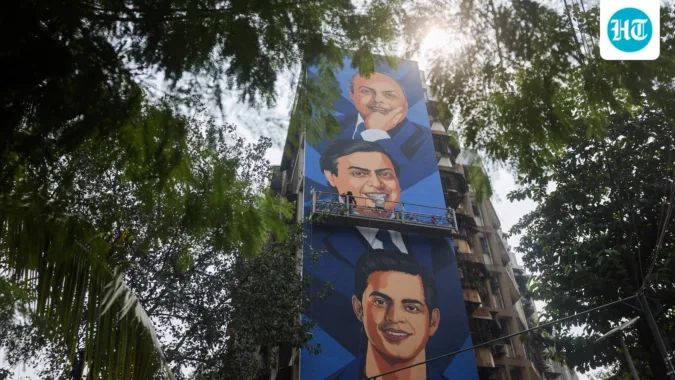 Reliance Group beats Tata to become biggest conglomerate by market valuation after Jio Platforms’ blockbuster debut An artist paints a mural featuring Reliance Industries founder Dhirubhai Ambani, Reliance Industries Chairman and Managing Director Mukesh Ambani, and Reliance Jio Infocomm Limited Chairman Akash Ambani. (Representative Image/Reuters)