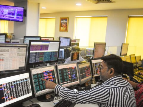 Share brokers track market movements on their computer screens at a trading office, in Kolkata. (ANI)
