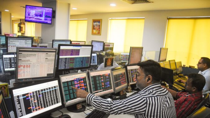 Share brokers track market movements on their computer screens at a trading office, in Kolkata. (ANI)