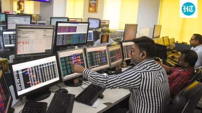 Share brokers track market movements on their computer screens as the Sensex and Nifty. (ANI)
