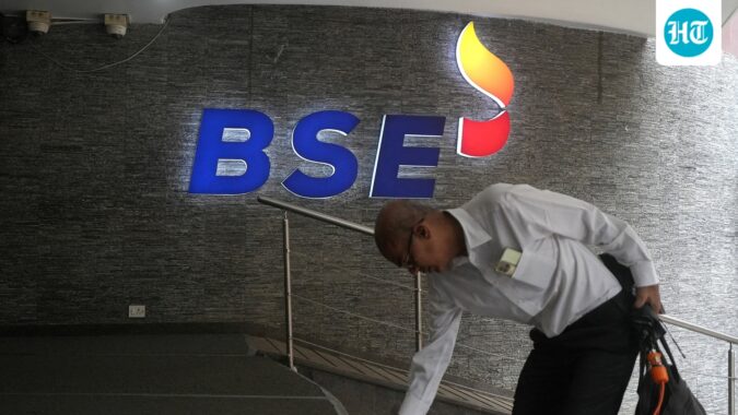A man touches the stairs as he arrives at the Bombay Stock Exchange (BSE) building in Mumbai (REUTERS/File)