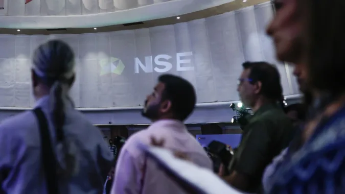 The National Stock Exchange of India Ltd. (NSE) logo on display during the company's listing ceremony at the Bombay Stock Exchange (BSE) in Mumbai on Sept 24 (Bloomberg)